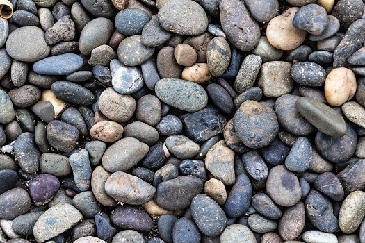 Premium Photo  A close up of a sand with small rocks and pebbles