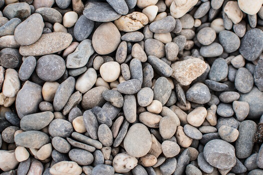 Premium Photo  A close up of a sand with small rocks and pebbles