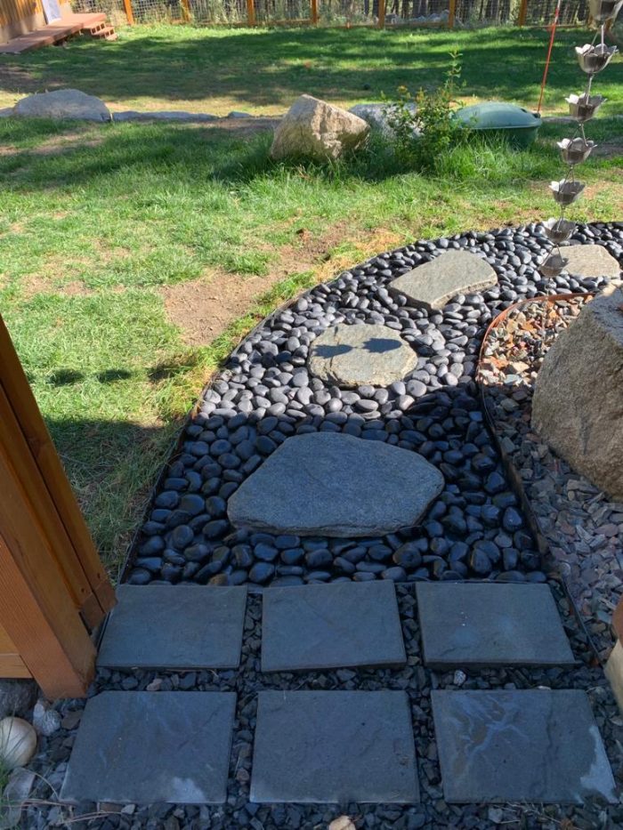 garden landscape with black beach pebbles